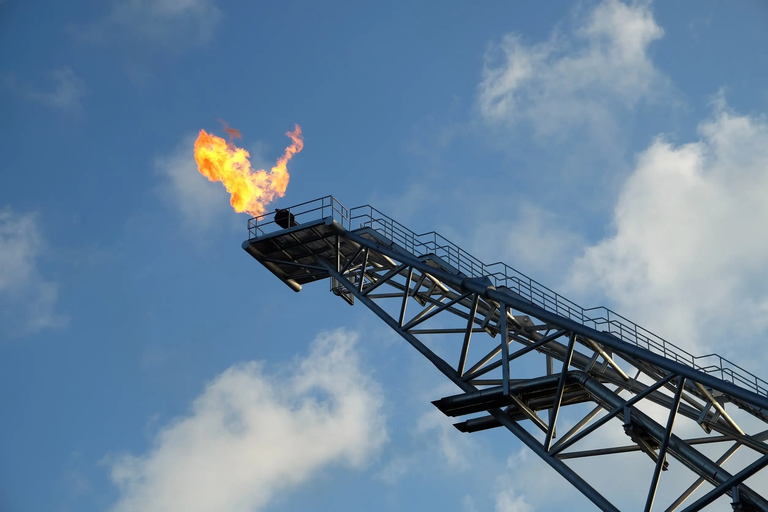 Industries OEM and equipment makers, featuring a flare stack emitting flames against a blue sky